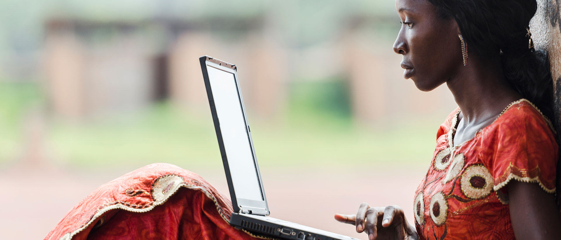African student doing research on a laptop